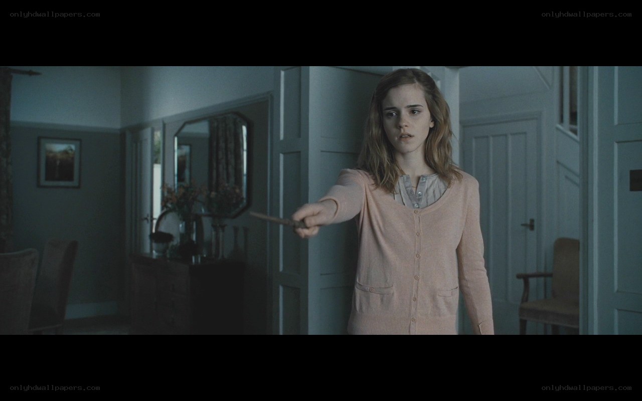 Hermione holding a wand