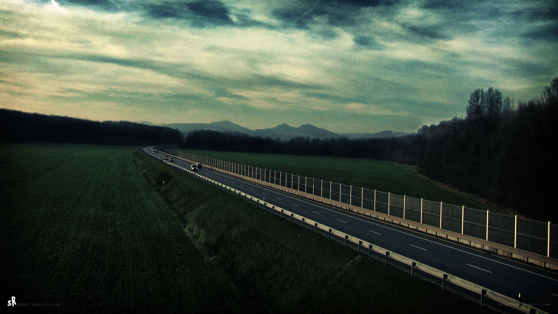 Highway at dusk with mountains