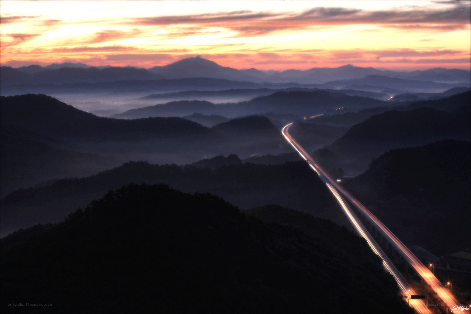 Highway at sunrise over mountains