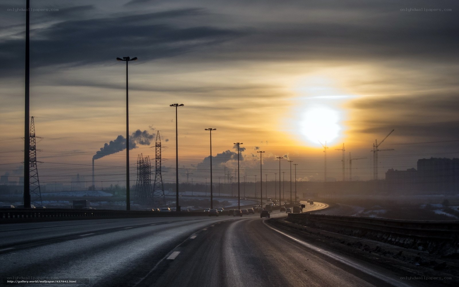 Highway at sunset with industrial backdrop