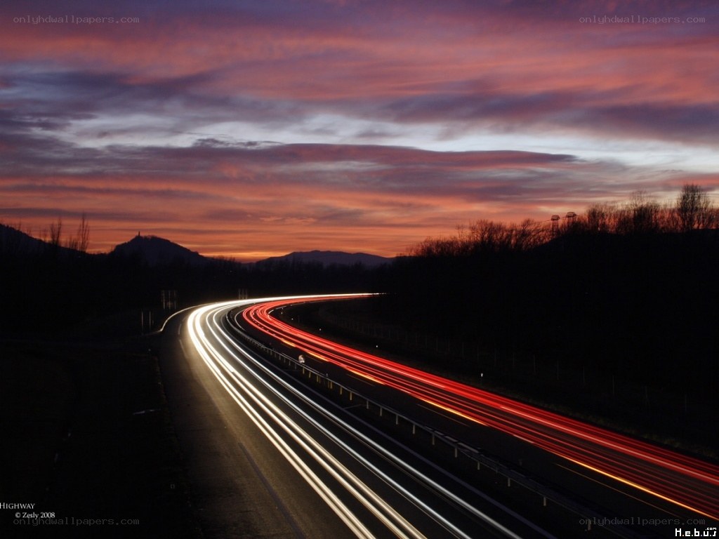 Highway at sunset with light trails