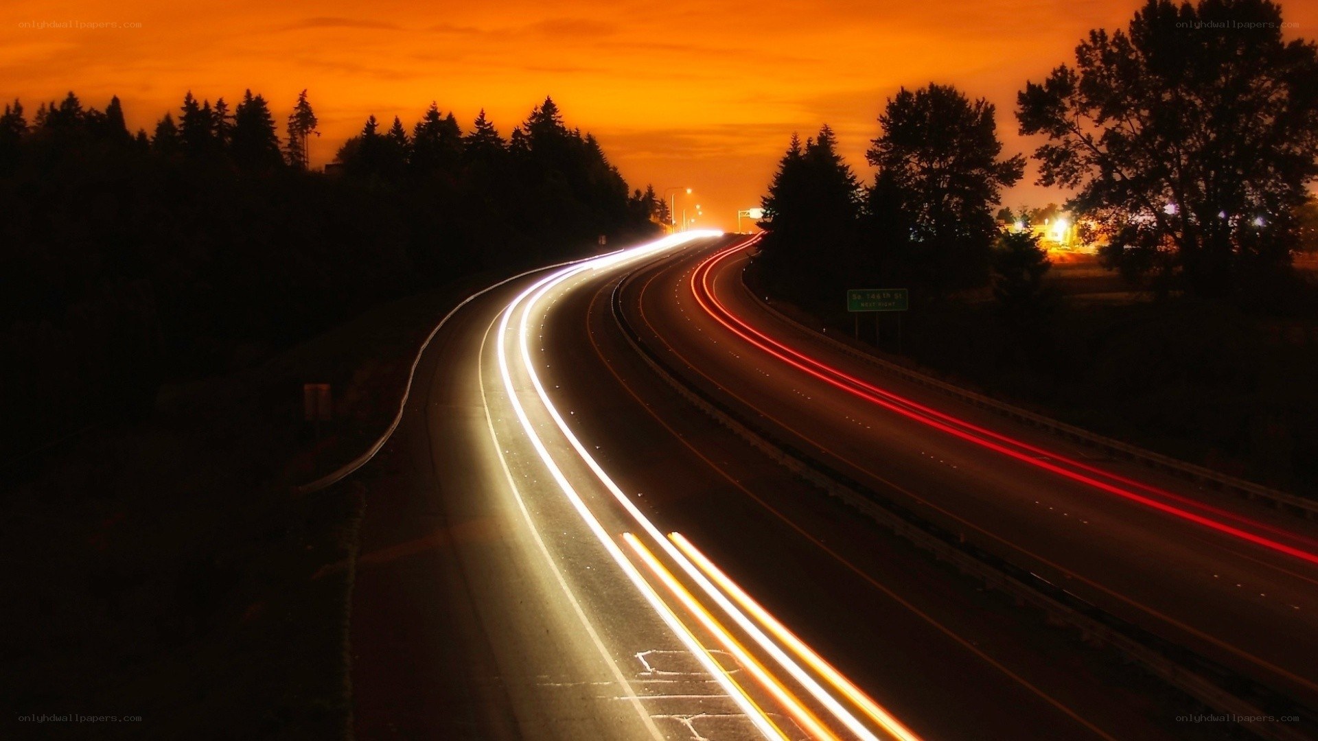 Highway at sunset with light trails