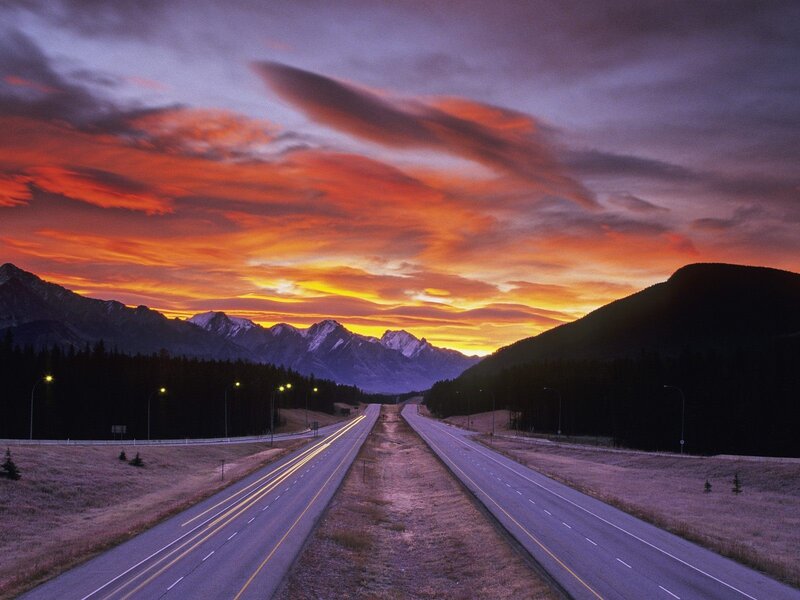 Highway at sunset with mountains