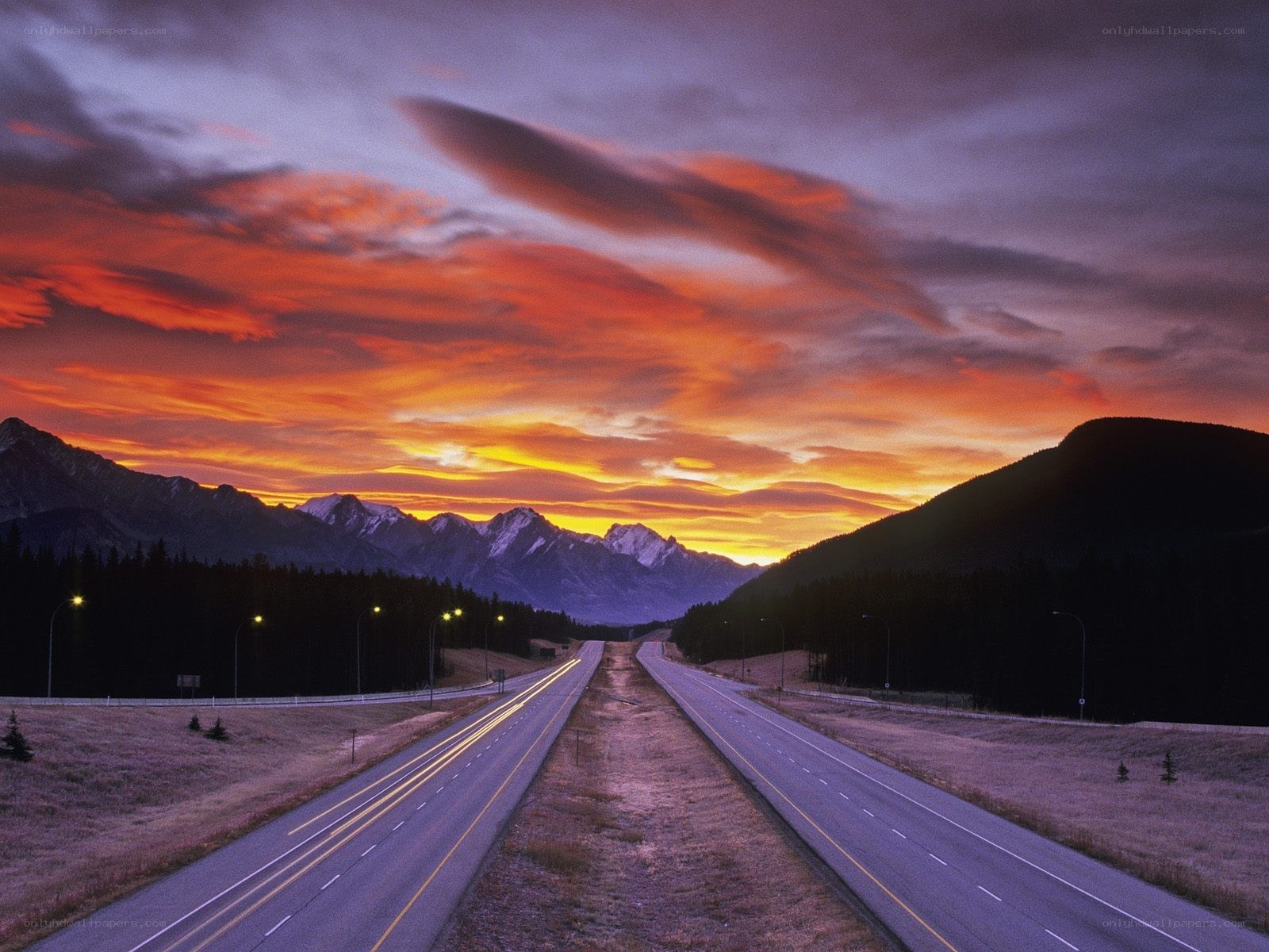 Highway at sunset with mountains