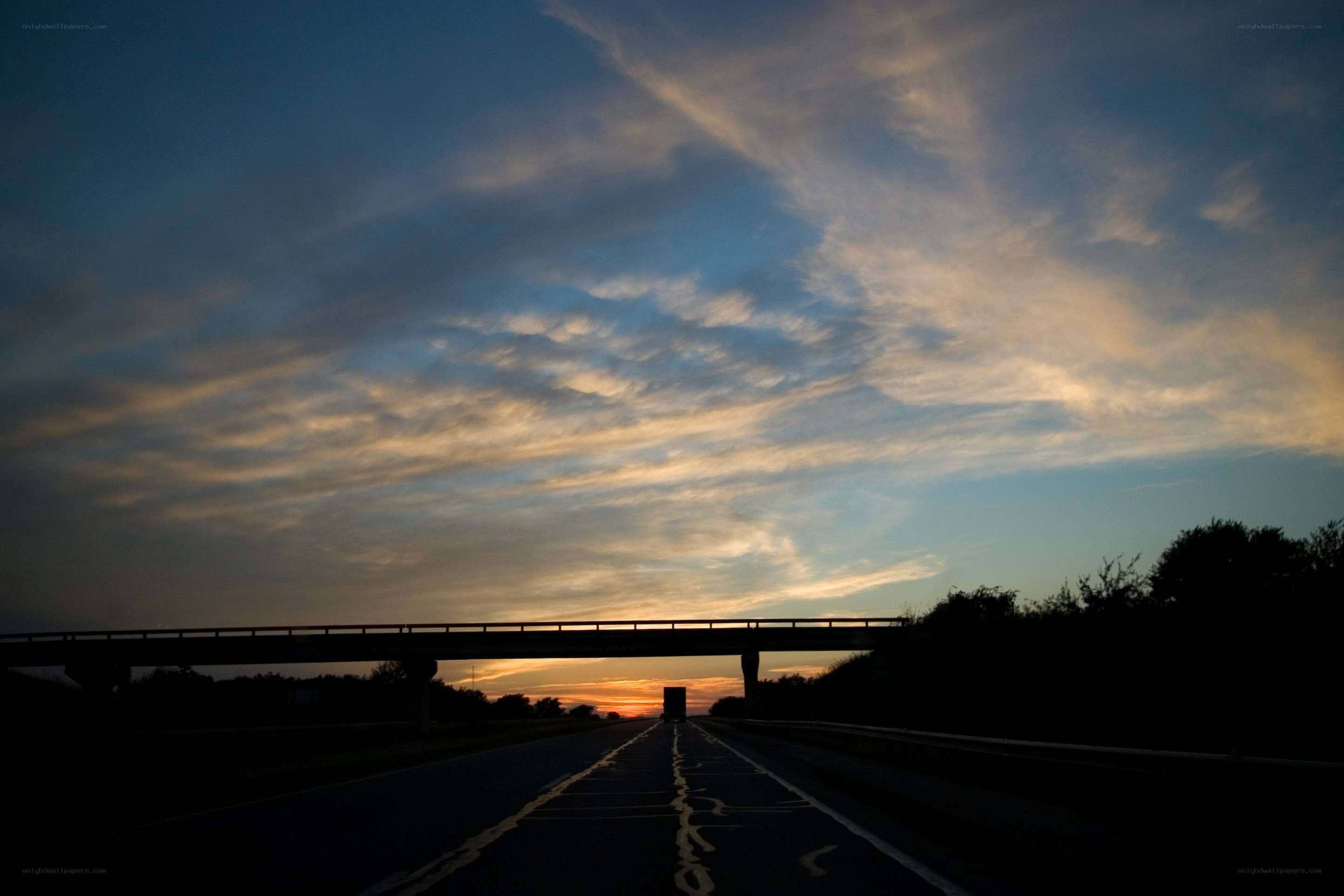 Highway at sunset with overpass