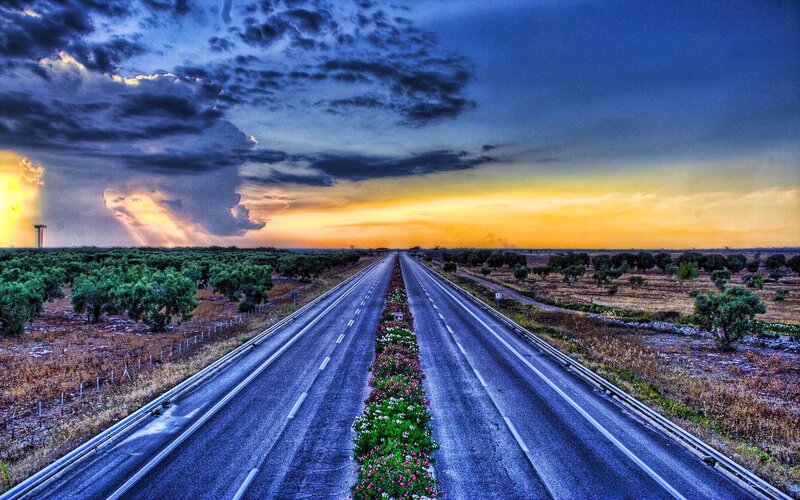 Highway at sunset with storm