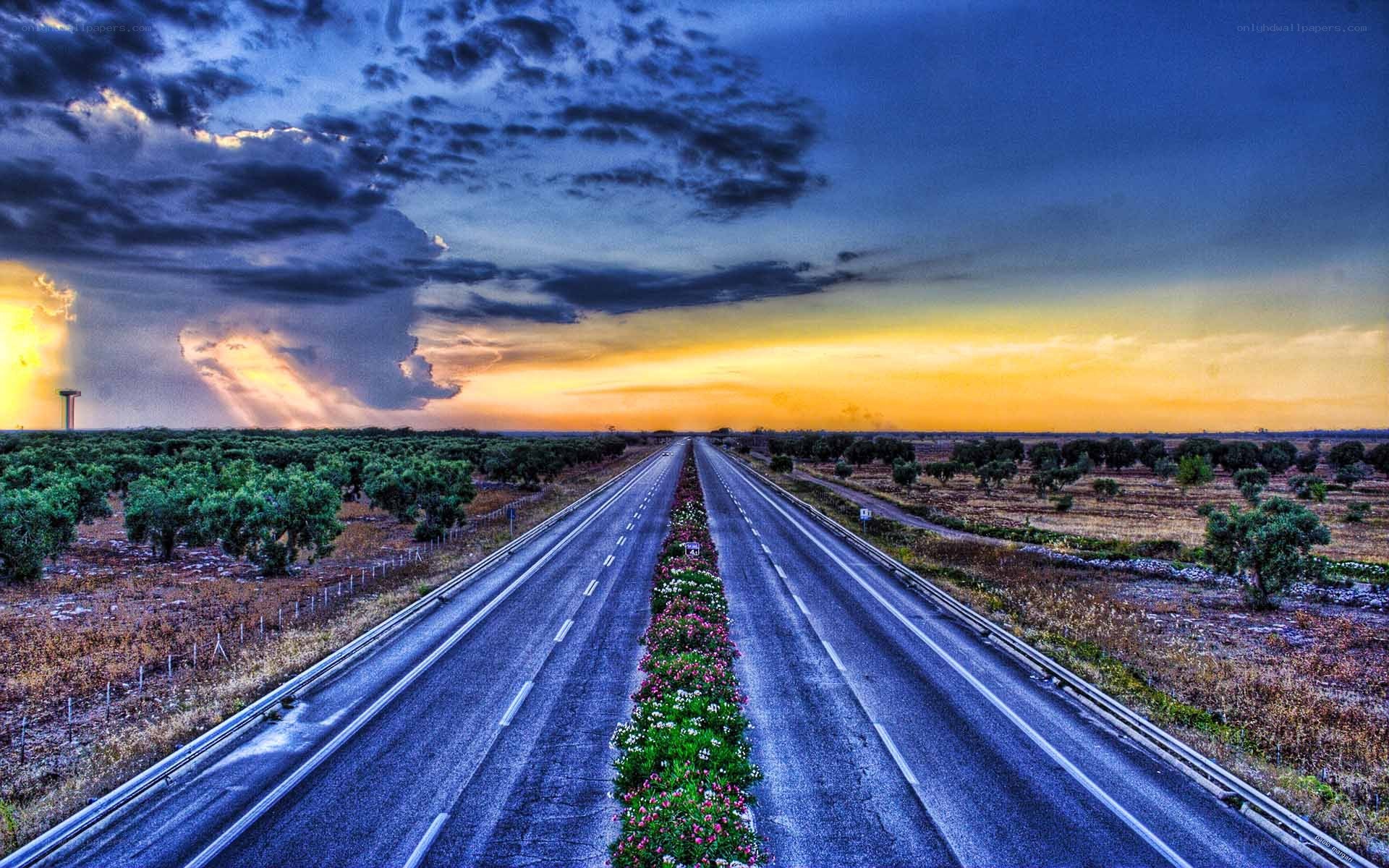 Highway at sunset with storm