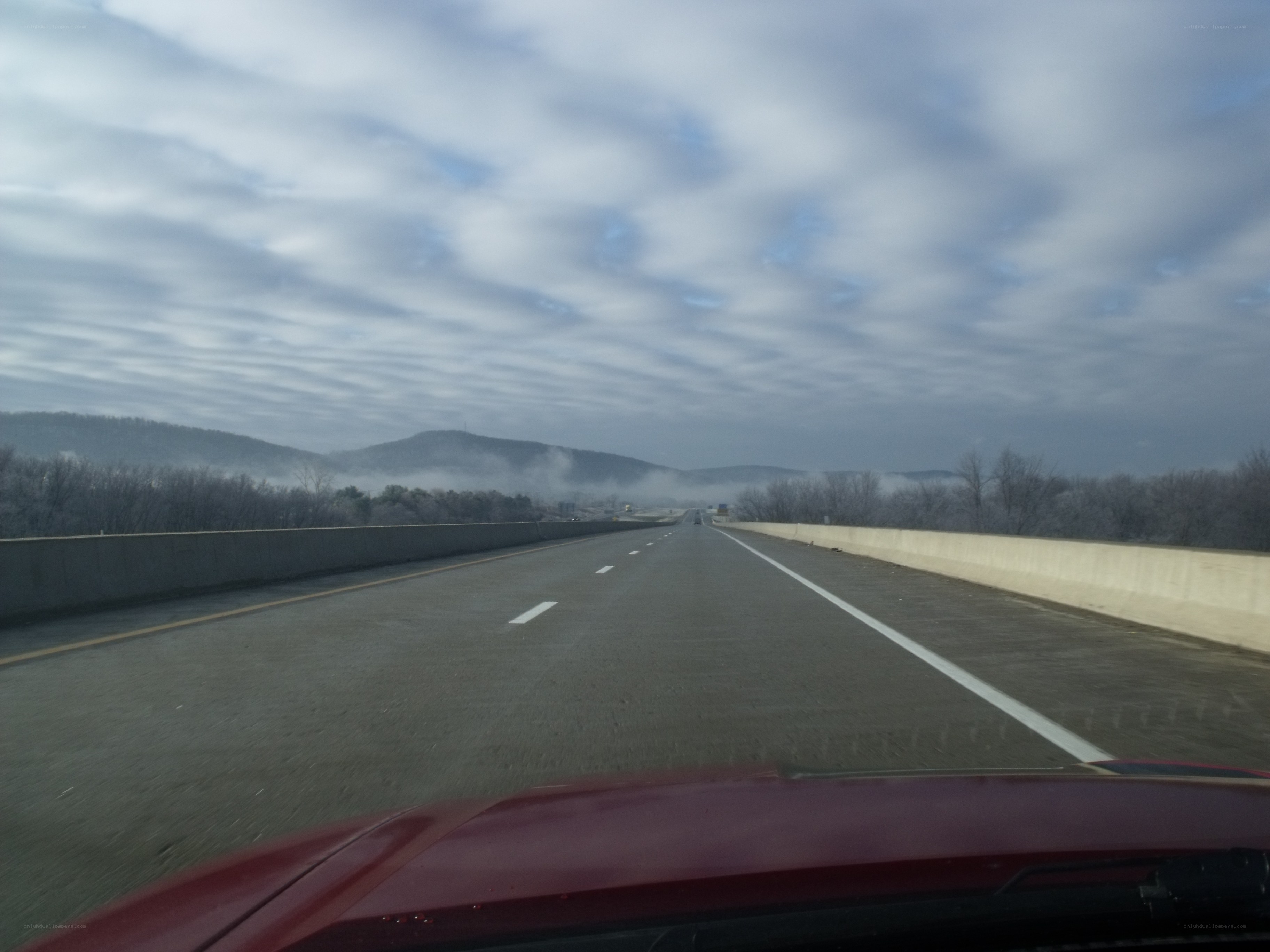 highway drive through foggy mountains