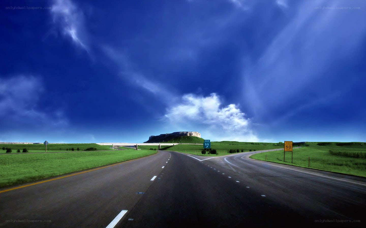 Highway leading to a distant hill