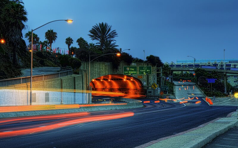 Highway tunnel at dusk with light trails