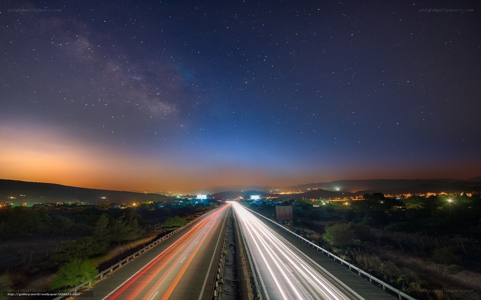 Highway under starry night sky