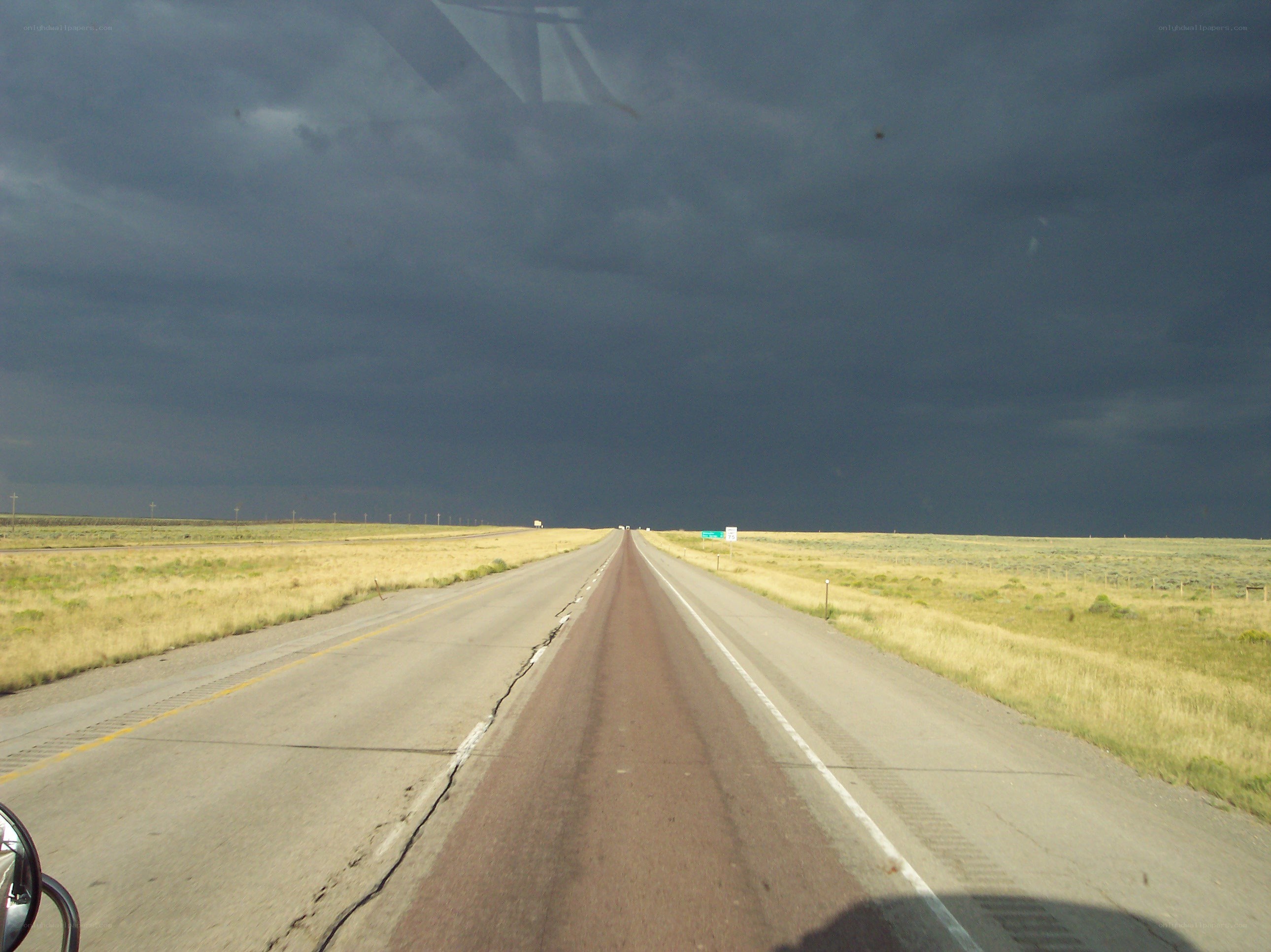 Highway under stormy sky