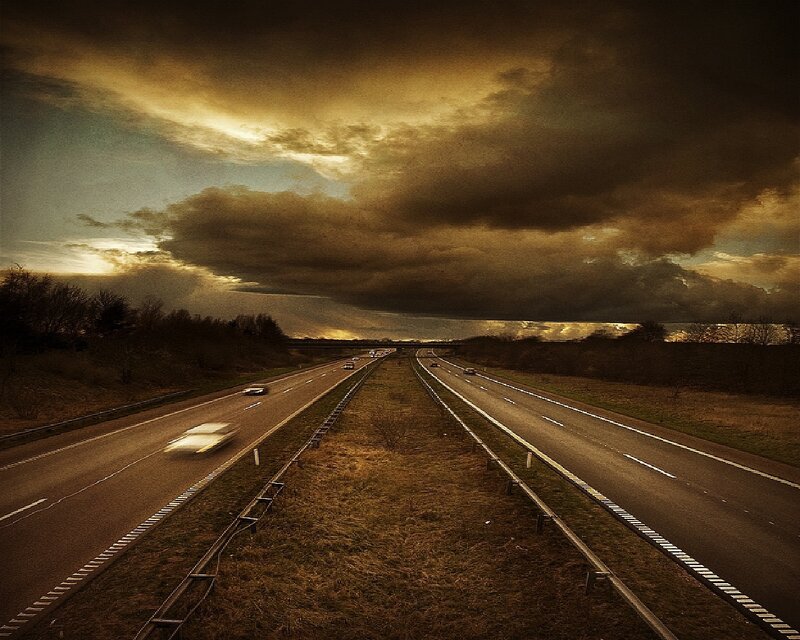 Highway under stormy sky
