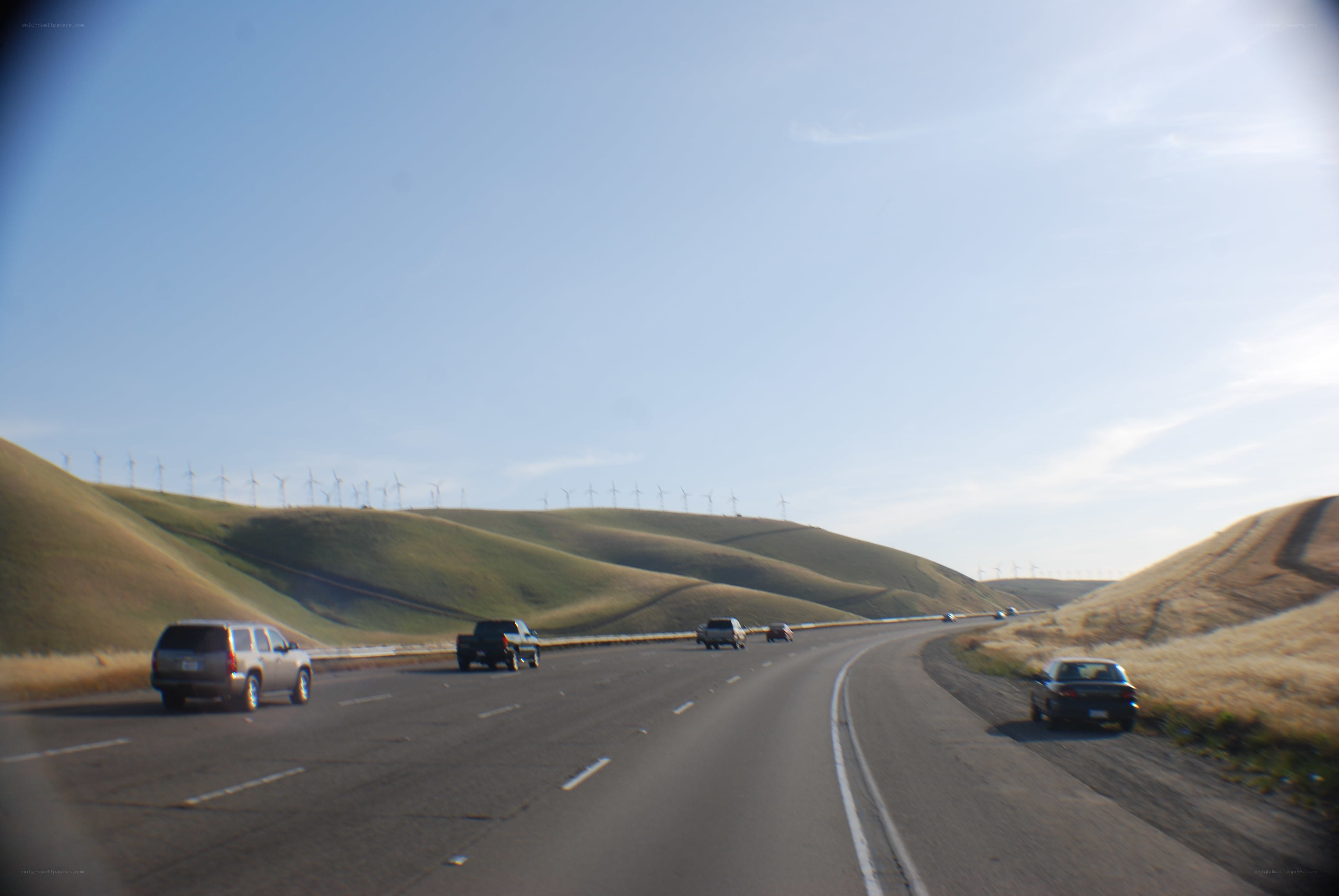 Highway with wind turbines in background