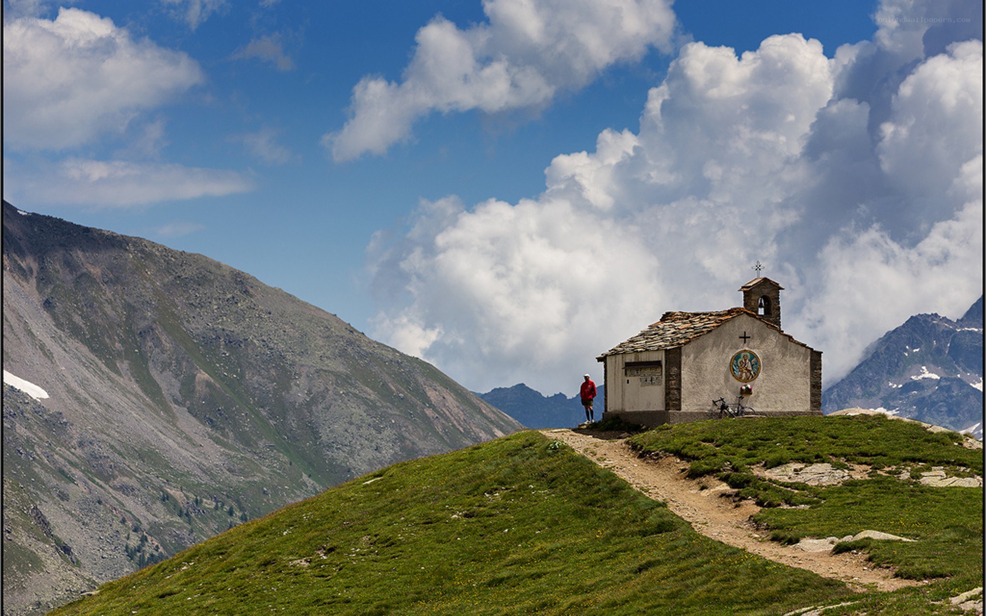 Hiker at mountain chapel