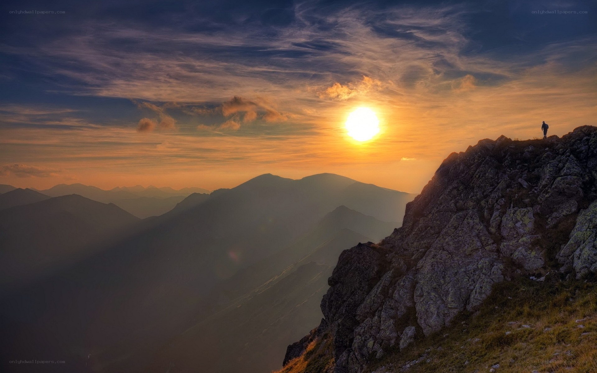Hiker at sunset on mountain