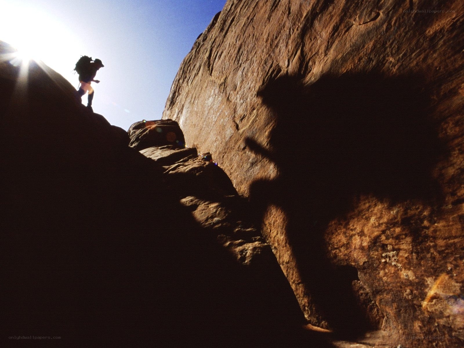 Hiker climbing rocky slope