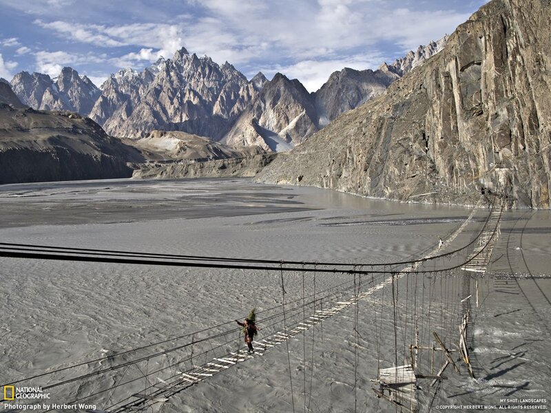 Hiker crossing a suspension bridge