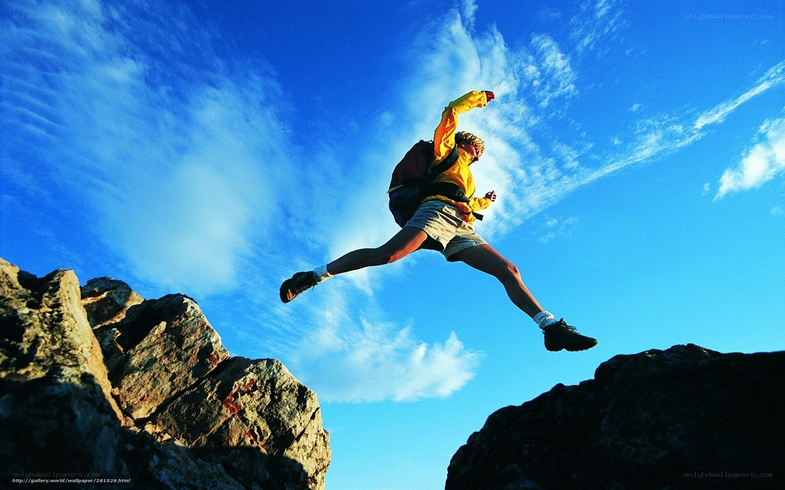 Hiker jumping between rocks