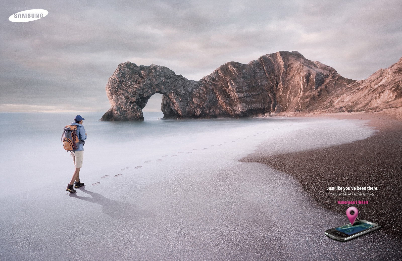 Hiker on a beach with arch