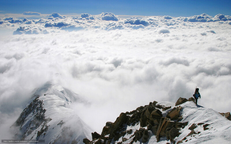 Hiker on a snowy mountain peak