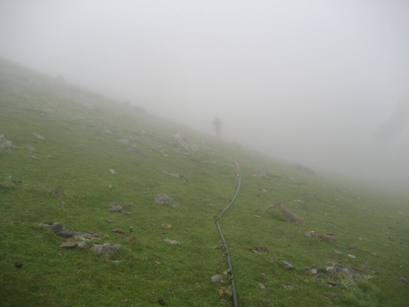 Hiker on foggy mountain trail