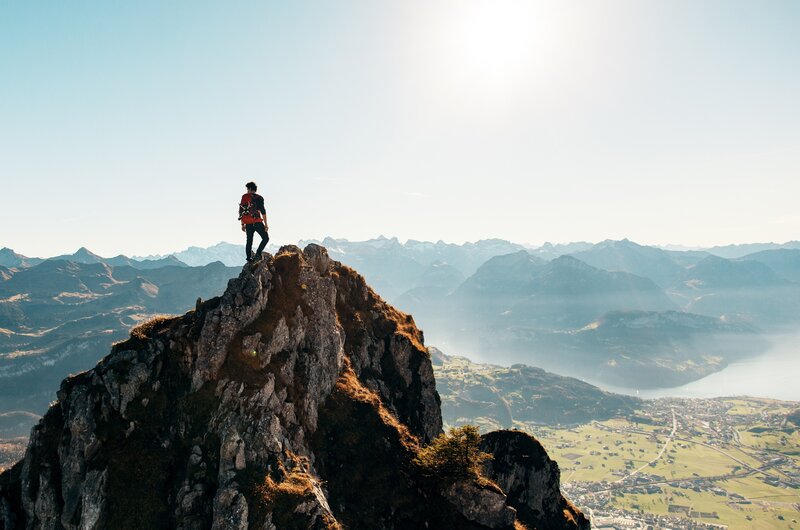 Hiker on Mountain Peak — Blue, Serene, Afternoon, Photograph, Mountains, Valley