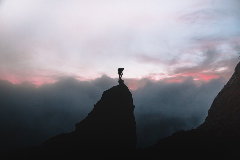 Hiker on Mountain Peak — Gray, Dramatic, Sunset