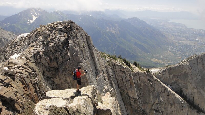 Hiker on Mountain Peak — Gray, Dramatic