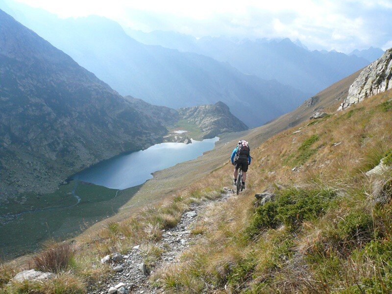 Hiker on mountain trail with lake view