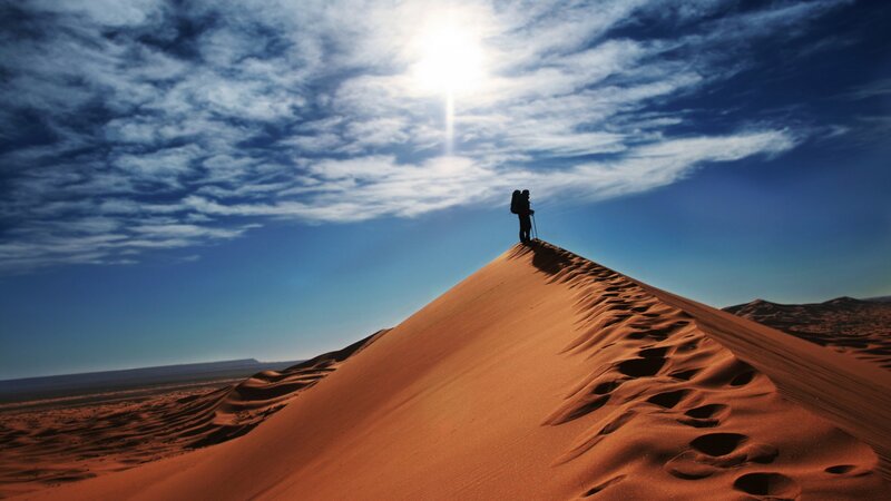Hiker on Sand Dune — Orange