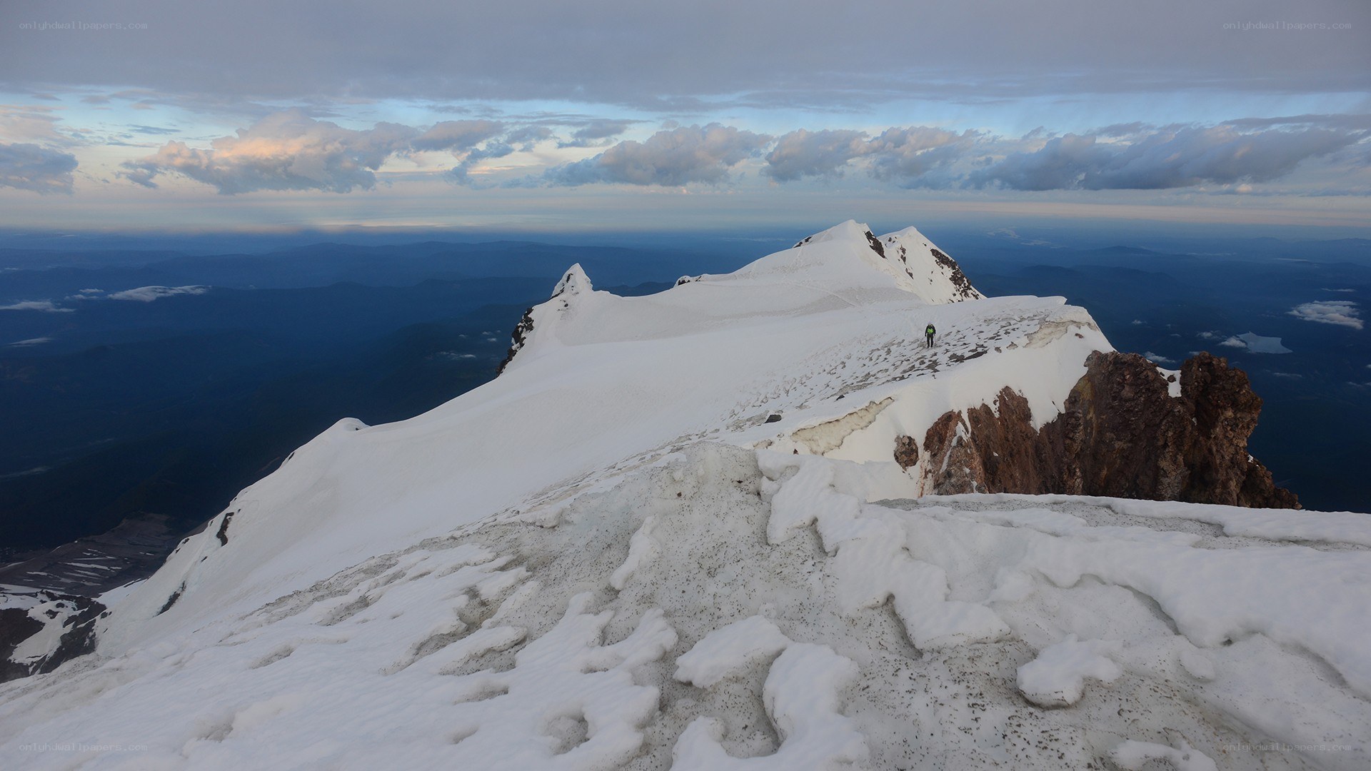 Hiker on snowy mountain peak