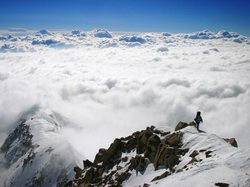 Hiker on snowy mountain peak