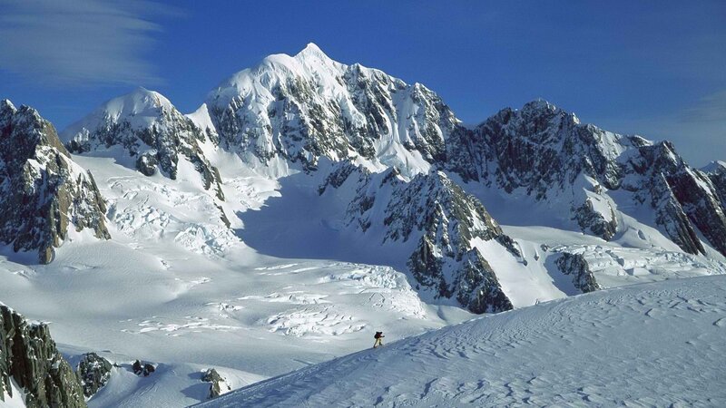 Hiker on snowy mountain slope