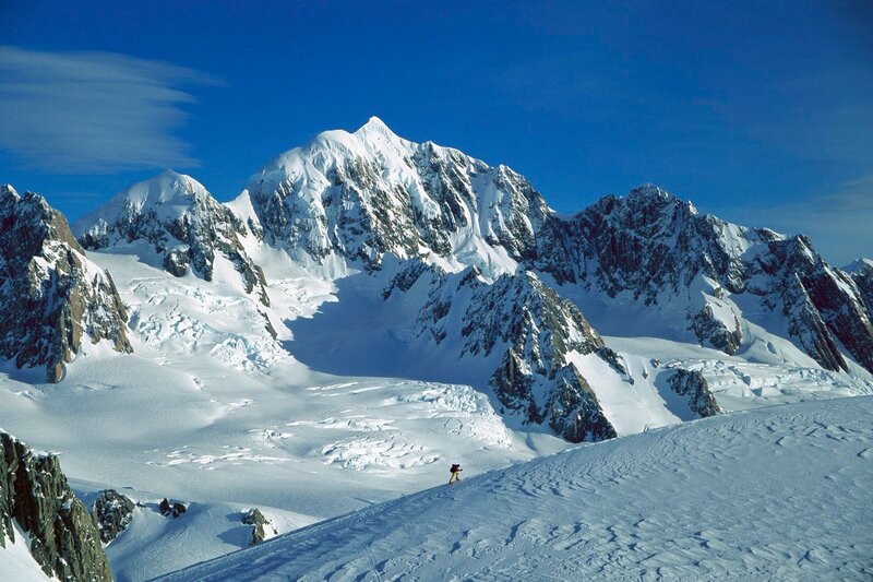 Hiker on snowy mountain slope