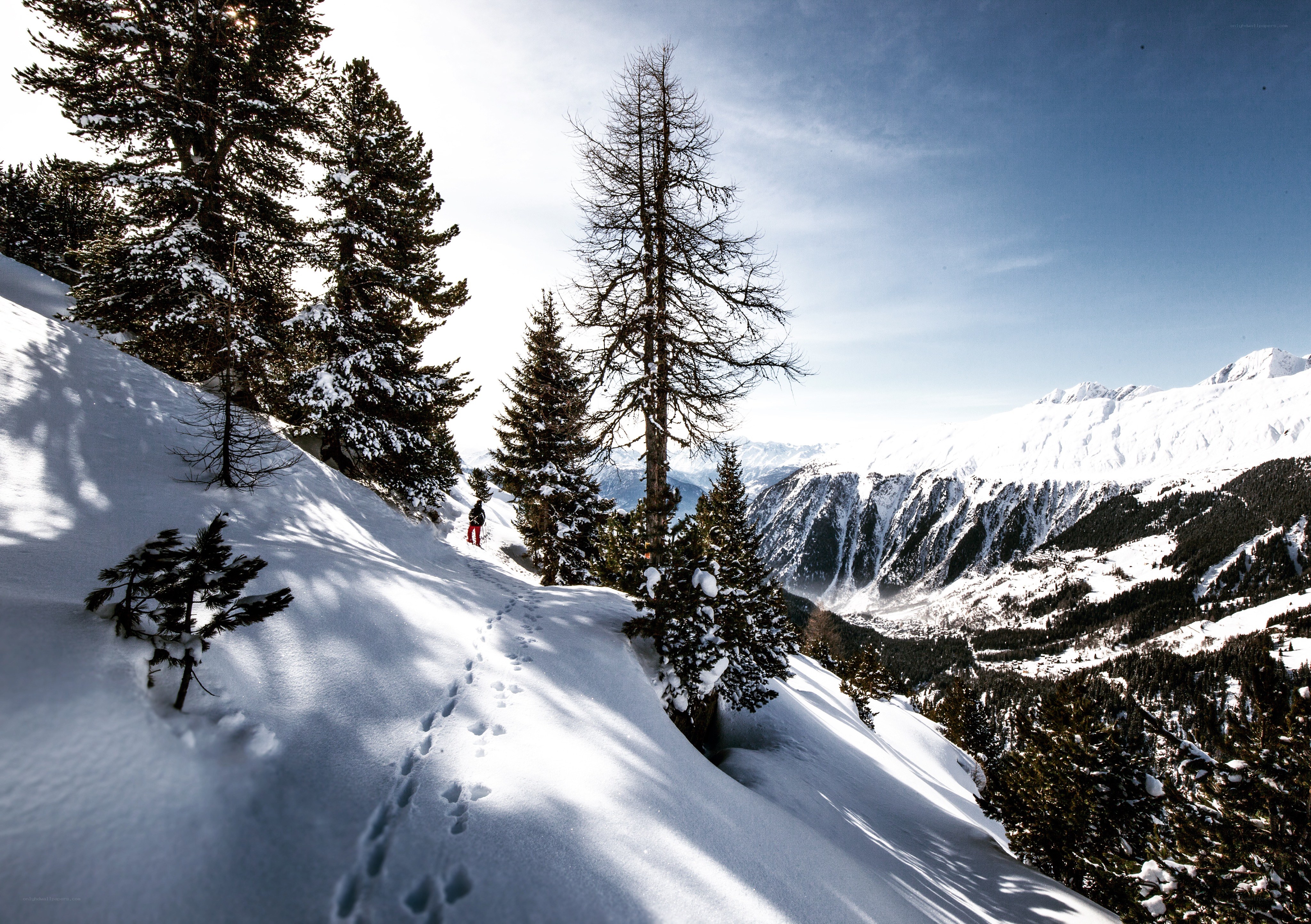 Hiker on snowy mountain trail