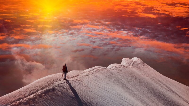 Hiker on Snowy Peak