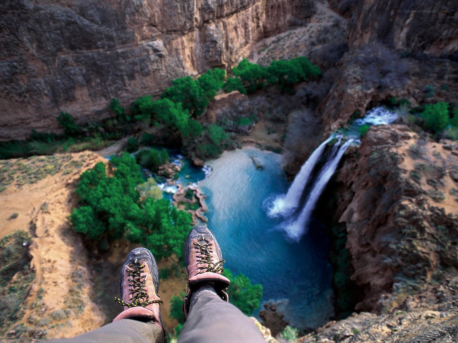 Hiker overlooking a canyon waterfall