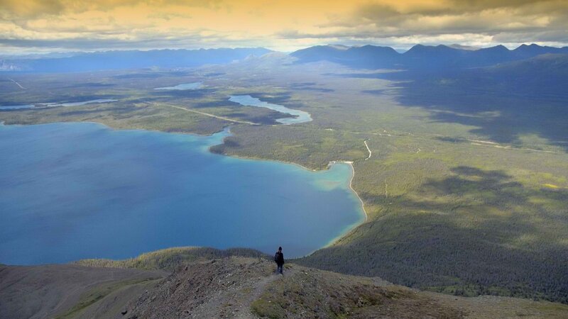 Hiker overlooking a vast Alaskan landscape
