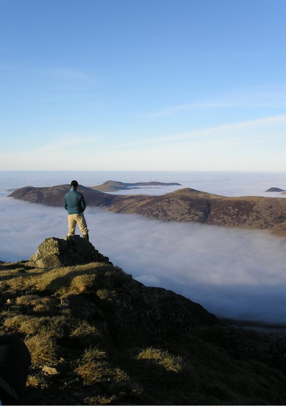 Hiker overlooking sea of clouds