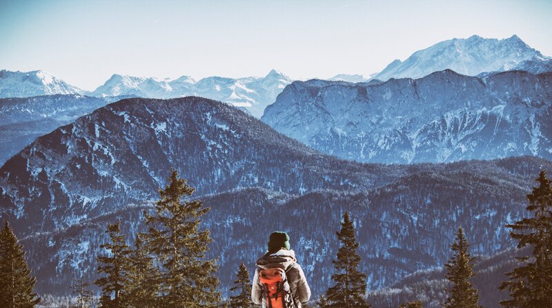 Hiker overlooking snowy mountains