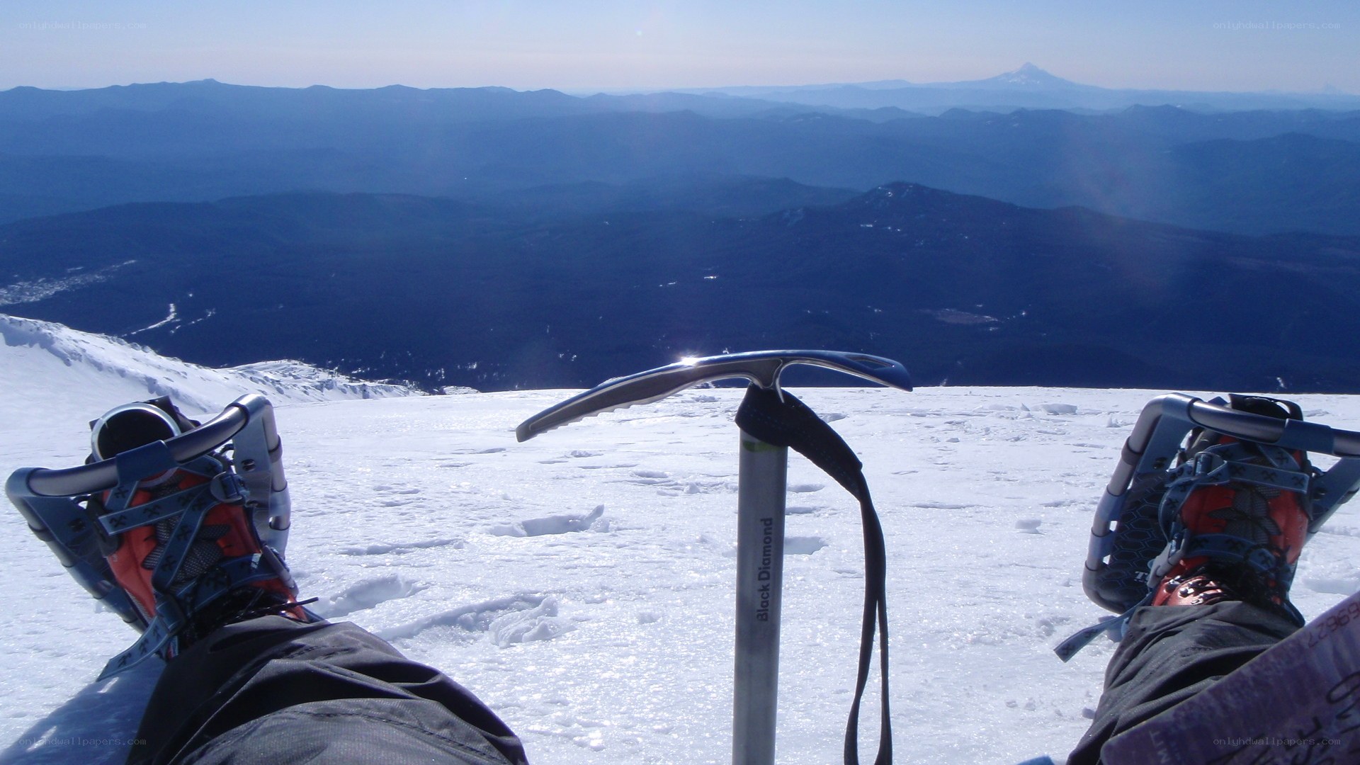 Hiker resting on snowy peak