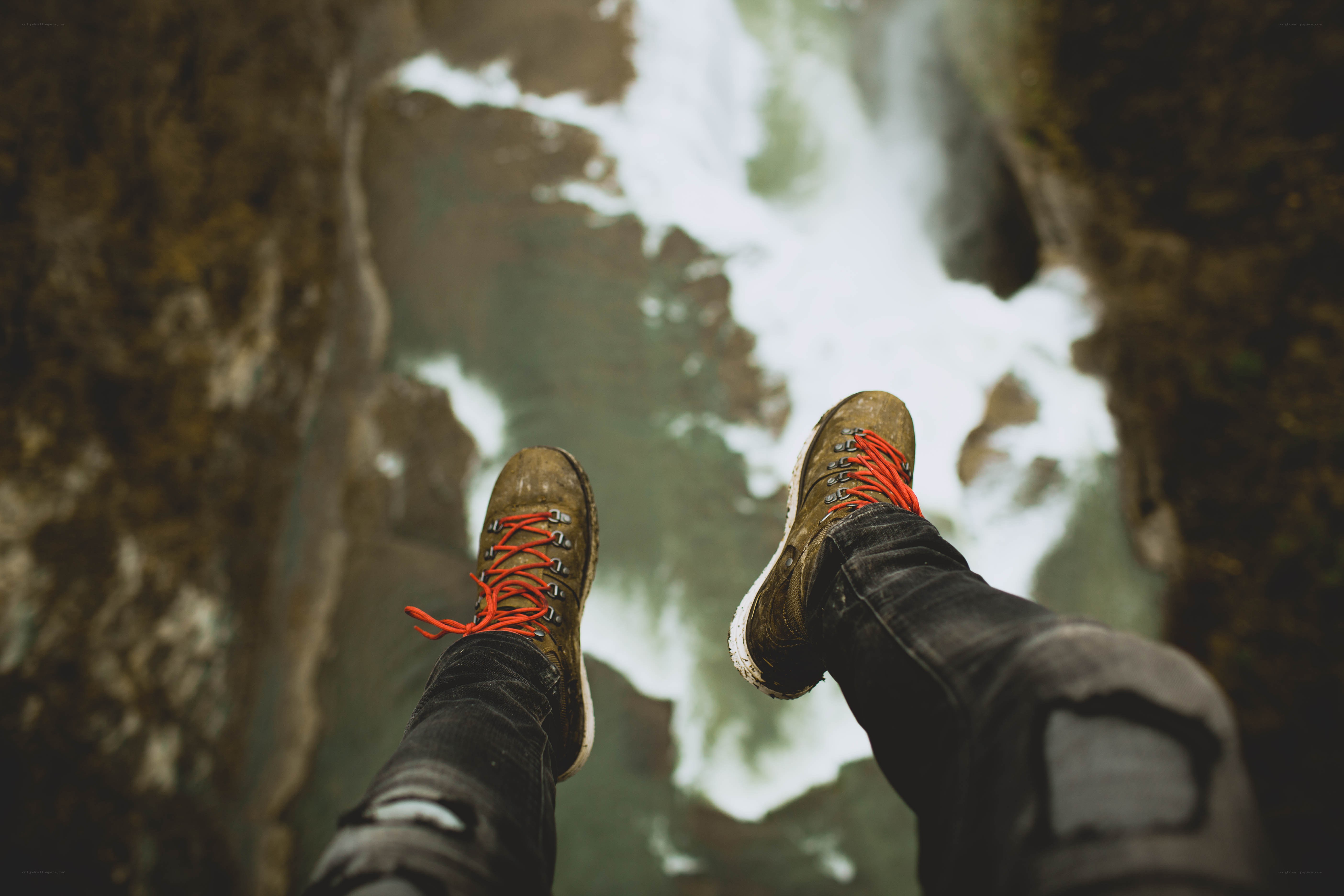 hiker's boots over a waterfall