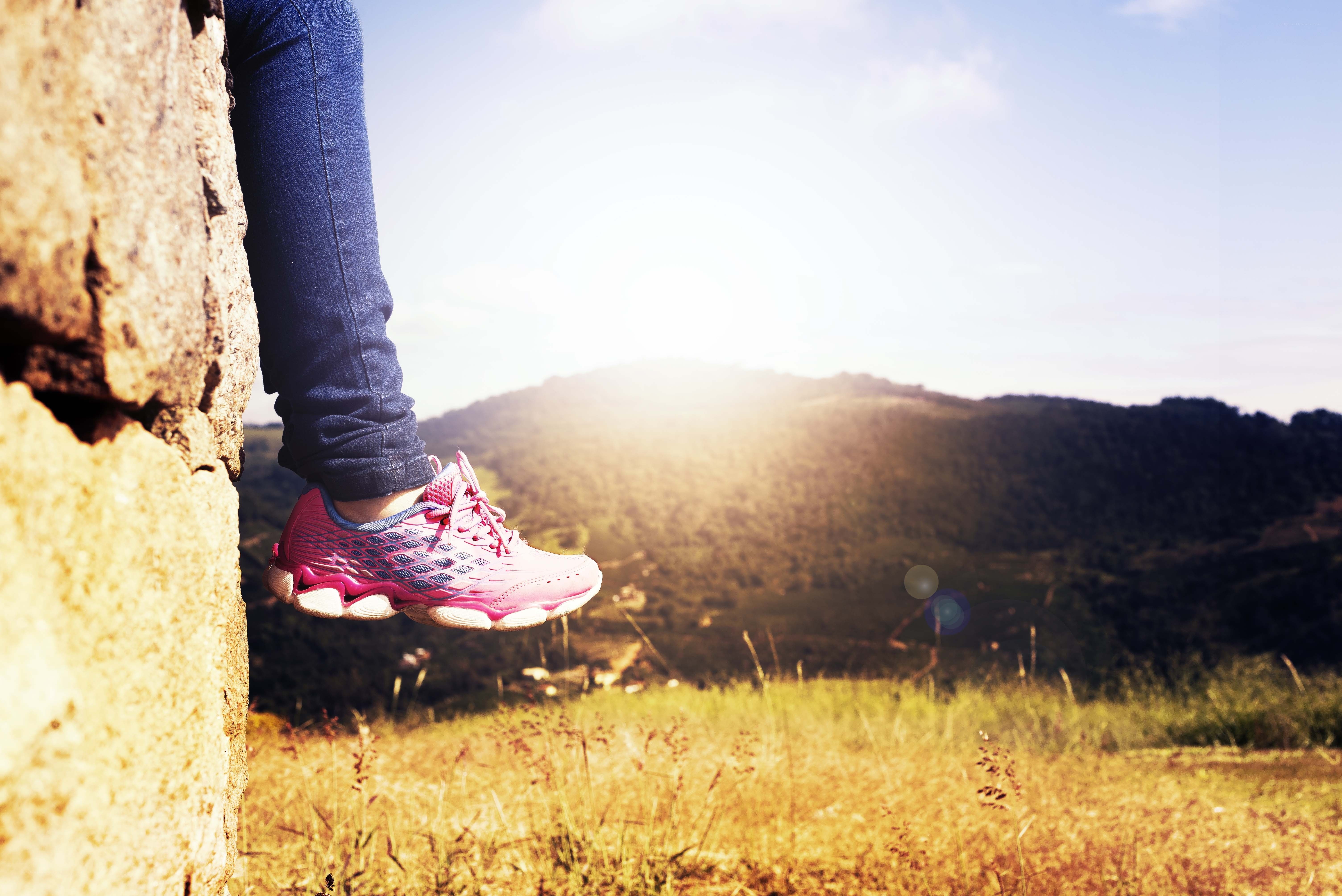 hiker's foot on a cliff