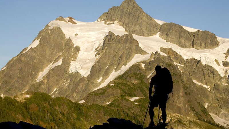 Hiker silhouetted against a mountain