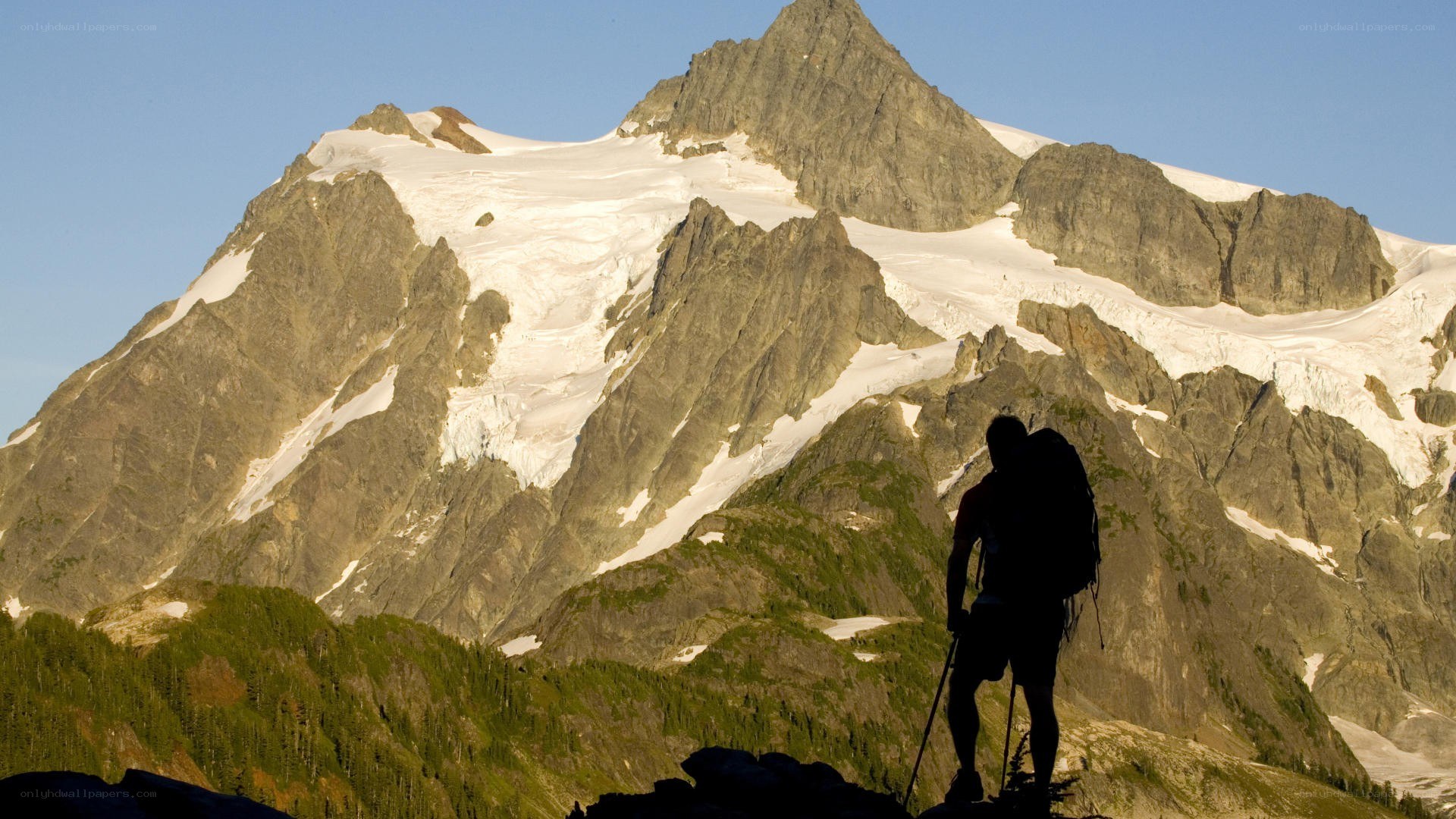 Hiker silhouetted against a mountain