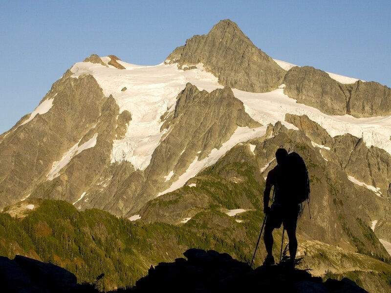 Hiker silhouetted against a mountain