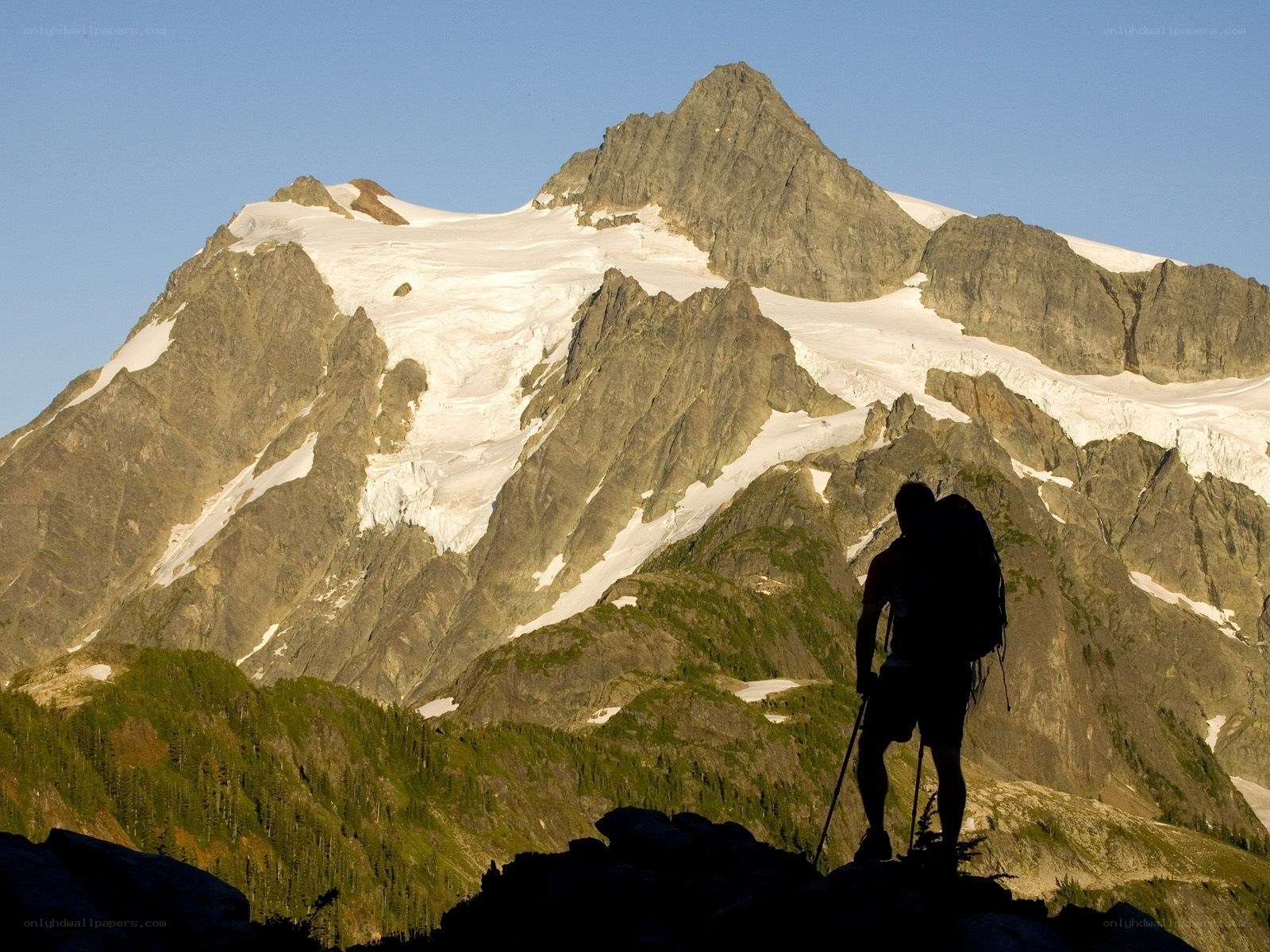 Hiker silhouetted against a mountain