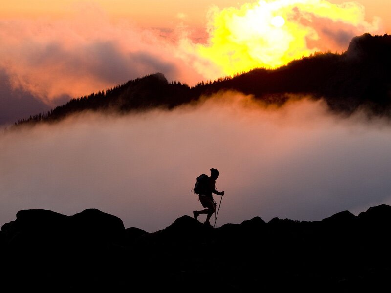 Hiker silhouetted at sunrise