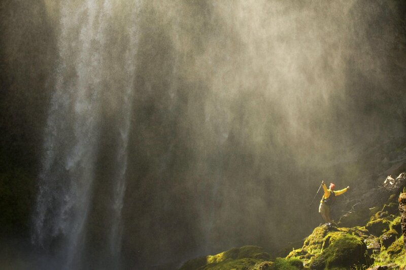 Hiker under a waterfall